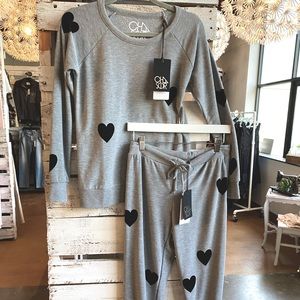 Women’s Chaser lounge pants. Grey base with small accent black hearts. Size L.